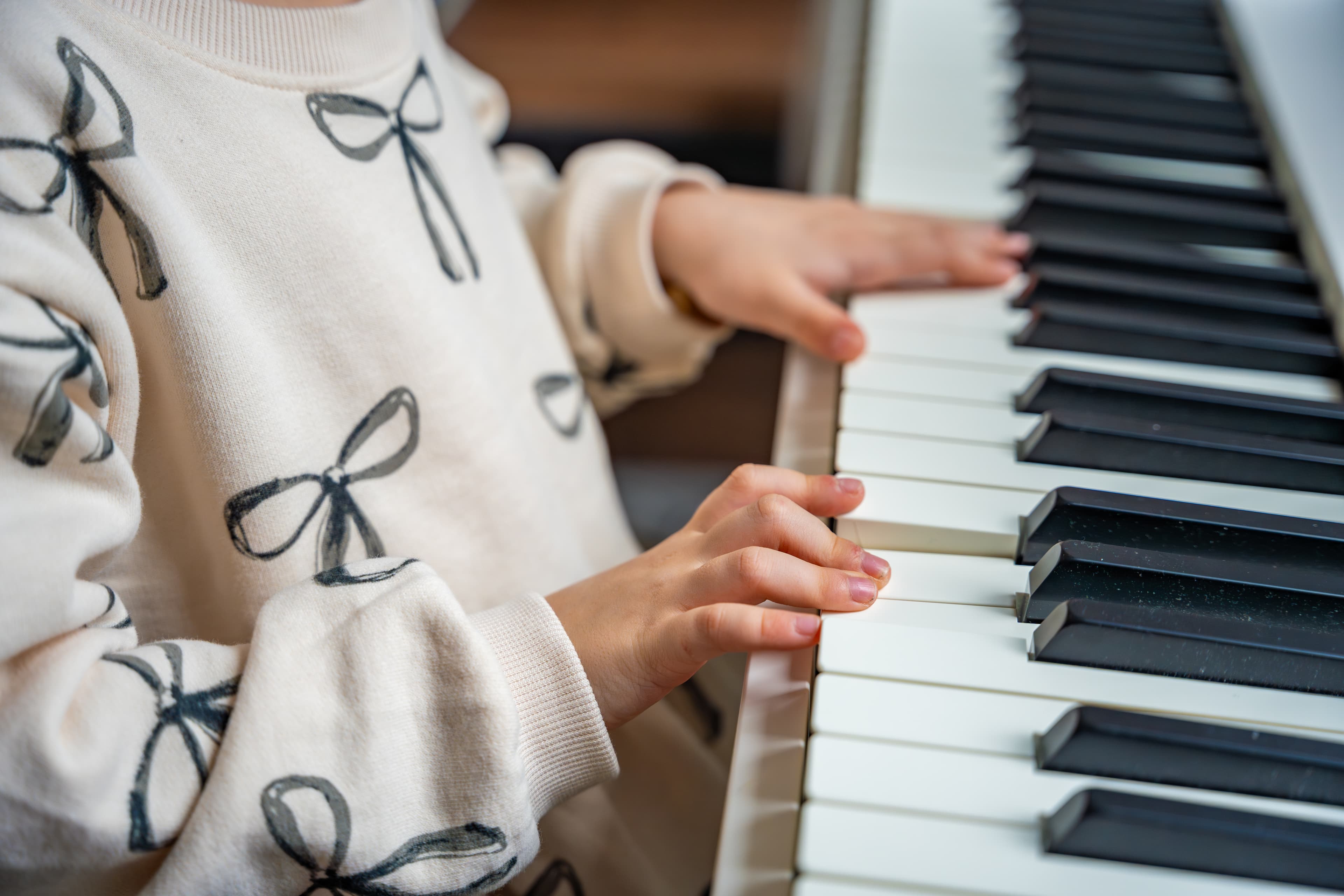 Child playing piano at home