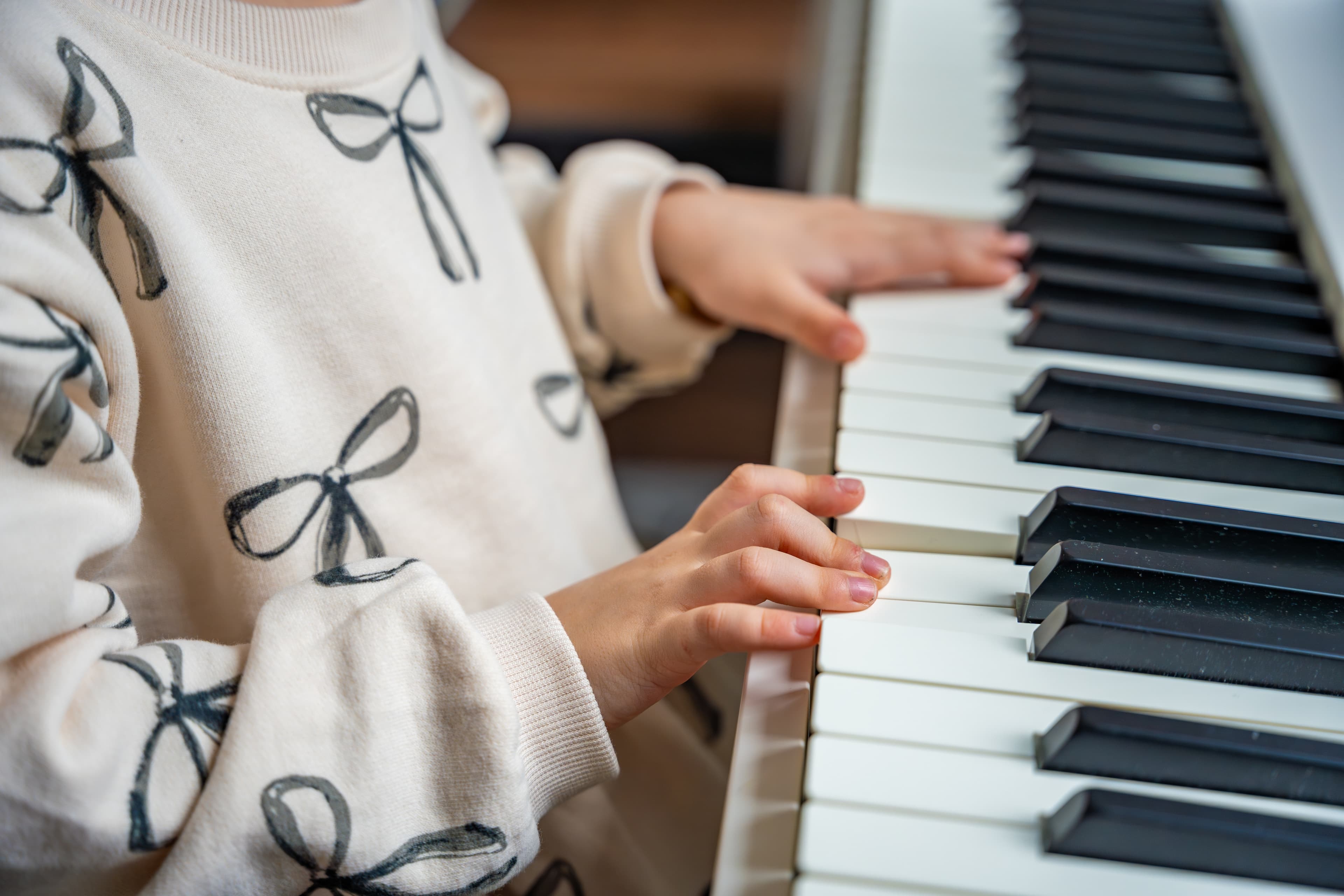 Child playing piano at home